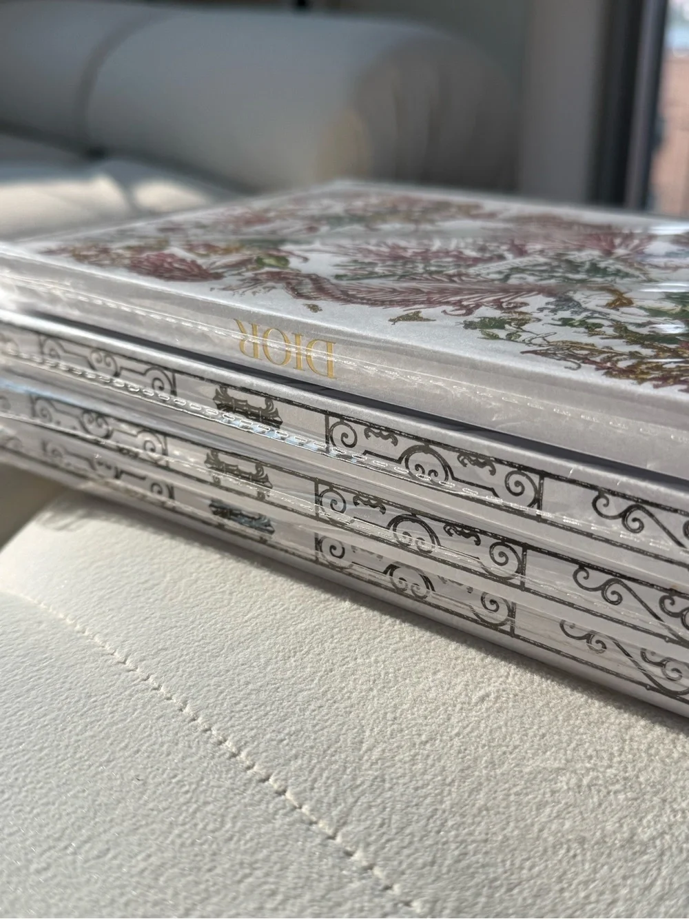 Dior notebooks with ornate gold and black designs